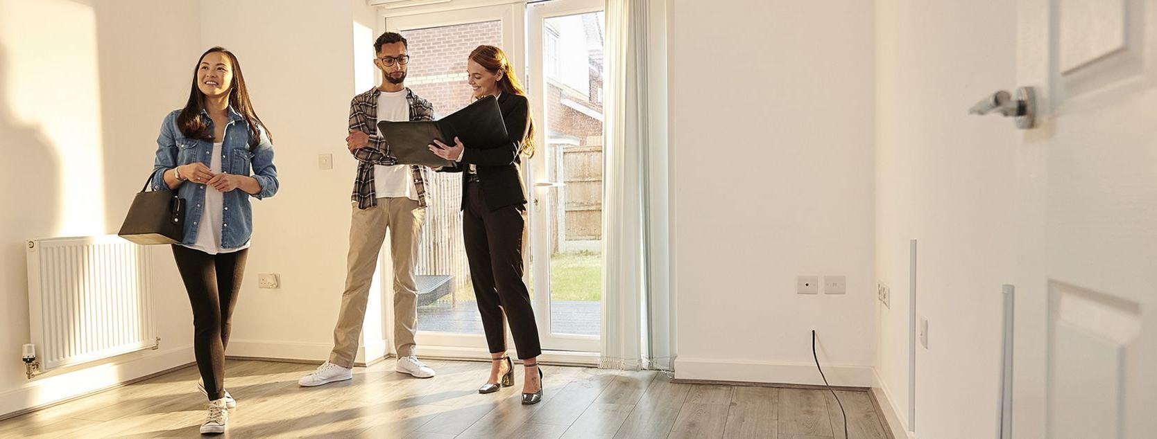 A couple tours a house with their real estate agent.